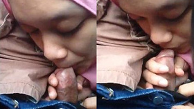 A beautiful girl with hijab gives a sensual blowjob to a small penis
