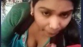 A charming Indian woman gives a sensual blowjob to her partner's penis