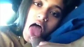 An Indian girlfriend performs oral sex on her boyfriend in a vehicle