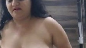 A sultry mother with large breasts passionately engages her companion in a steamy video