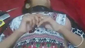 This hot video features a southern Indian woman showing off her intimate parts