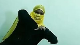 A girl in a hijab crawls with a dever