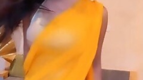 SEDUCTIVE BEAUTY IN A YELLOW SARI WITH AN OPEN BACK IS SEXY